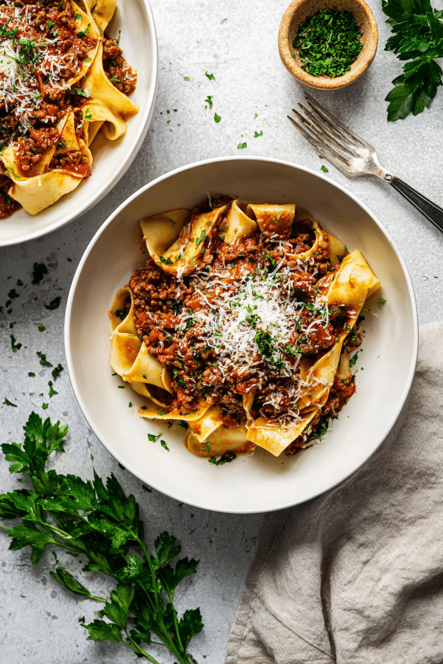 Serving Easy Lamb Mince Ragu with Pappardelle Bowls of Easy Lamb Mince Ragu ready to be served with parmesan