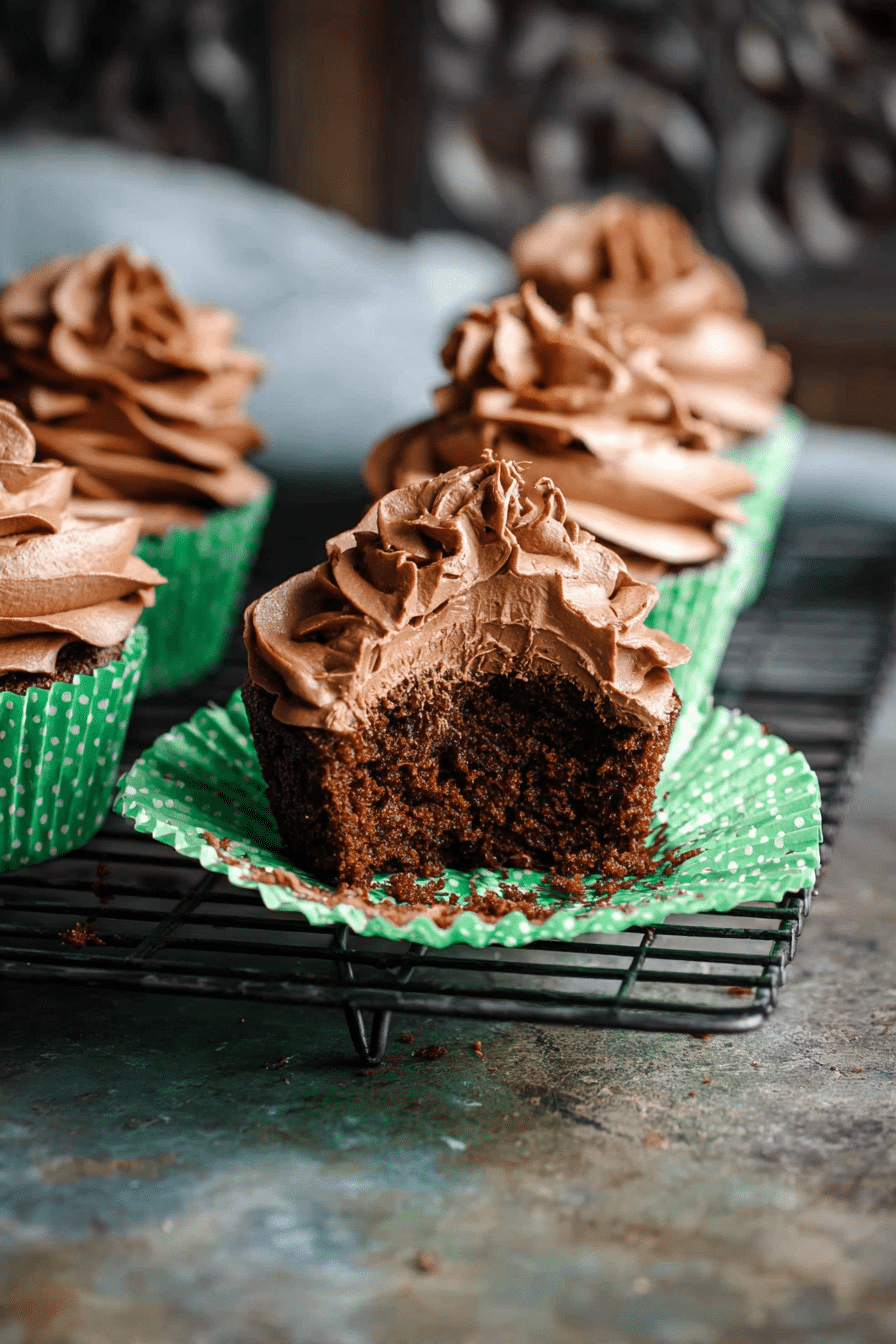 Keto chocolate cupcake with a bite taken out Bitten keto chocolate cupcake showing moist texture inside