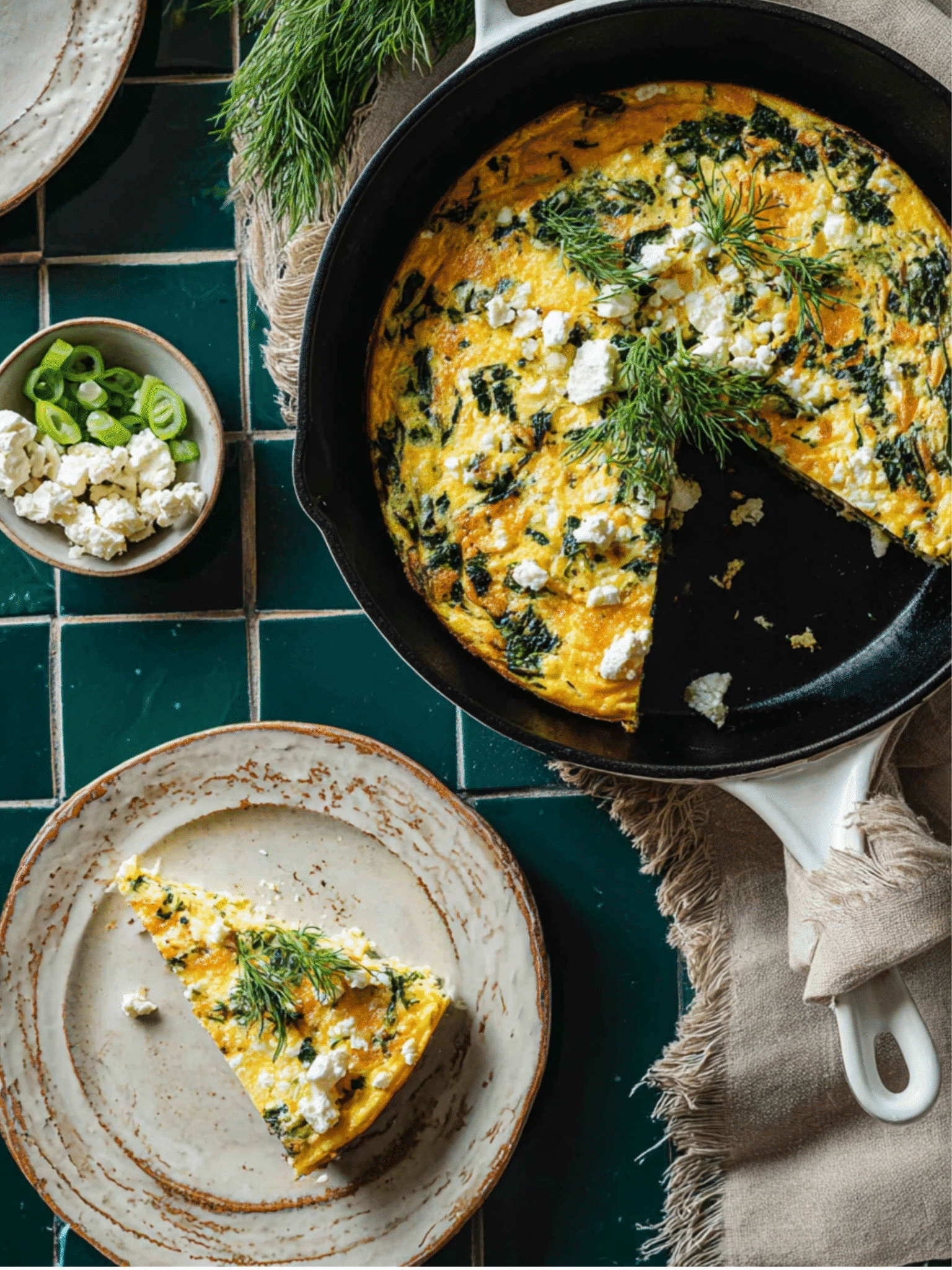 Sliced Spinach and Feta Crustless Quiche Ready to Serve Sliced spinach and feta crustless quiche served on a plate