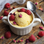 Tasty keto vanilla mug cake with decorative raspberries and petals
