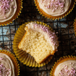 Vanilla cupcake with white whipped ganache frosting and sprinkles