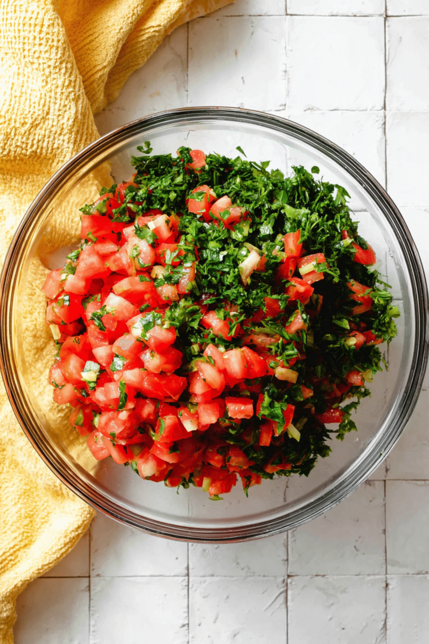 Preparing Arabic Salad with Fresh Tomatoes and Herbs Chopped tomatoes and parsley in glass bowl for Arabic salad preparation