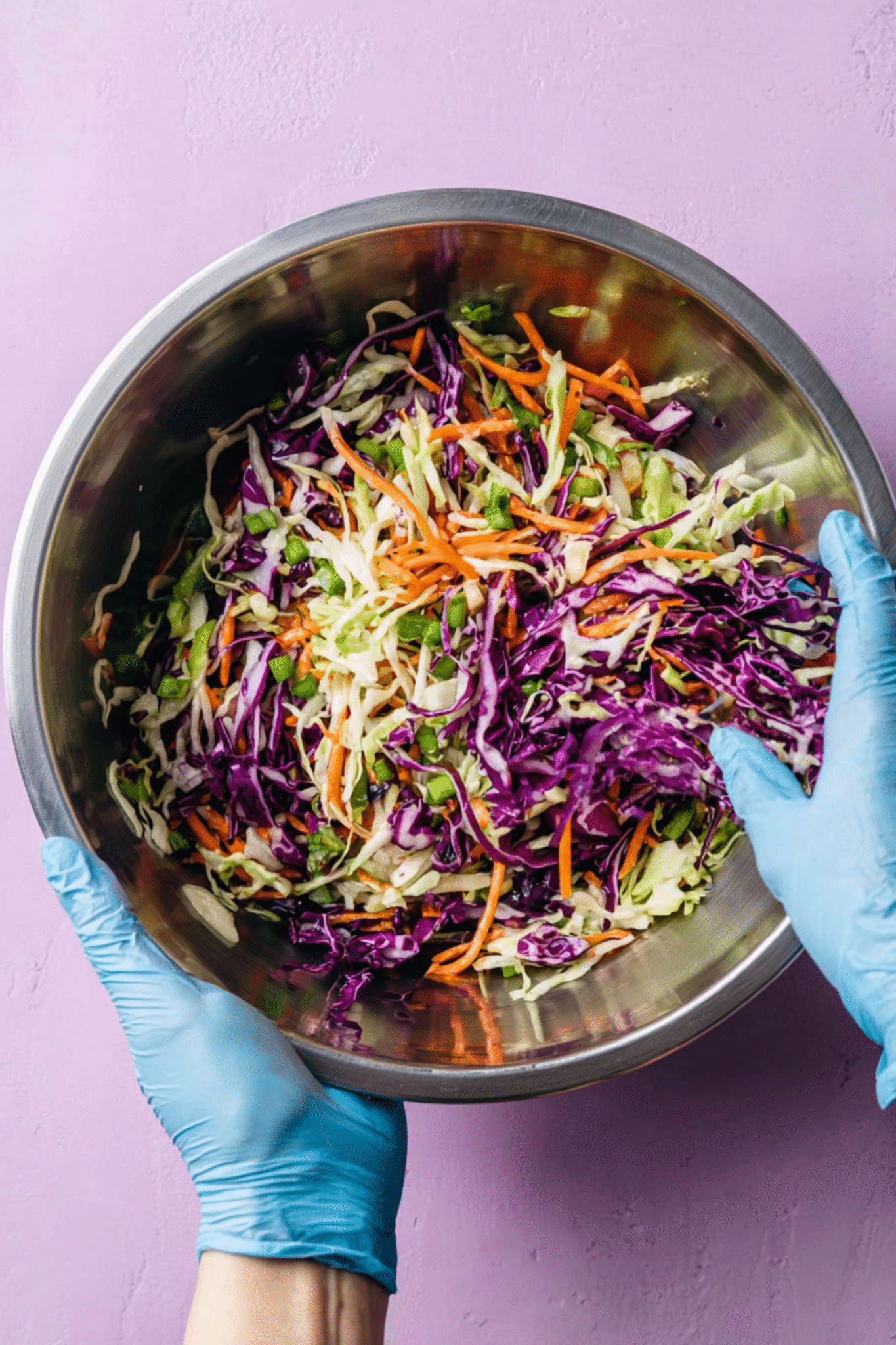 Preparing Cabbage and Carrot Salad Preparing cabbage and carrot salad in mixing bowl