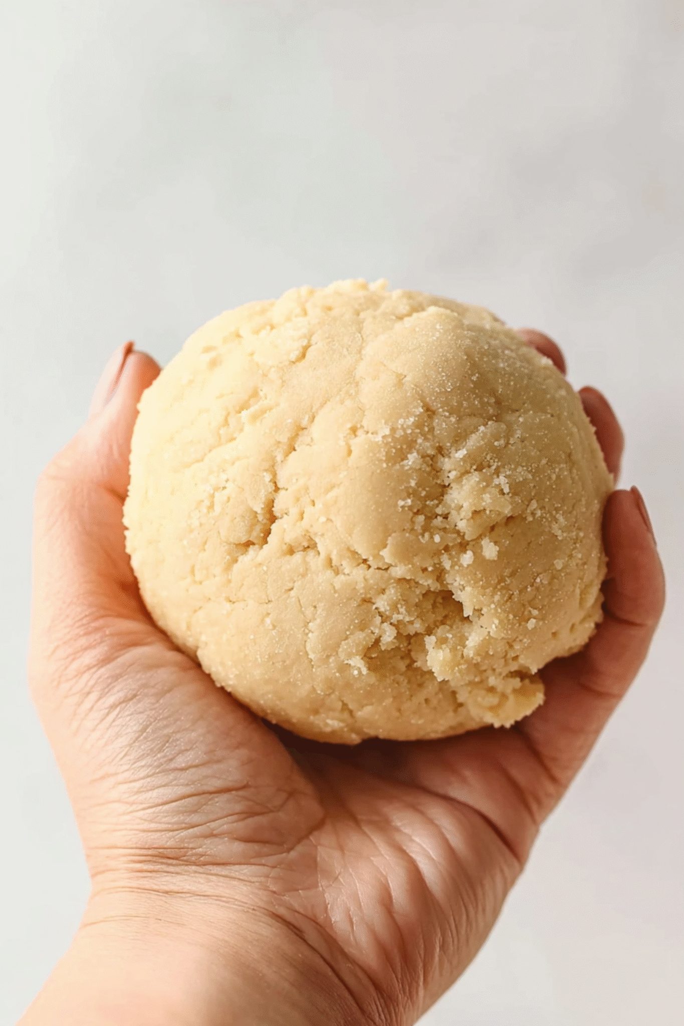 Preparing Almond Flour Dough for Quiche Crust Ball of almond flour dough being held before pressing into crust