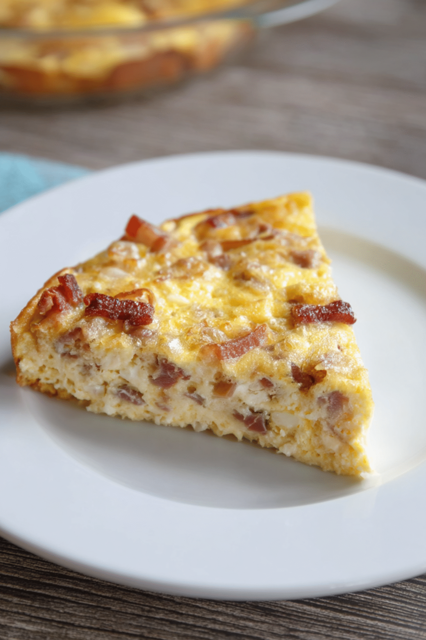 Plated Slice of Keto Crustless Quiche Lorraine Slice of Keto Crustless Quiche Lorraine served on white plate
