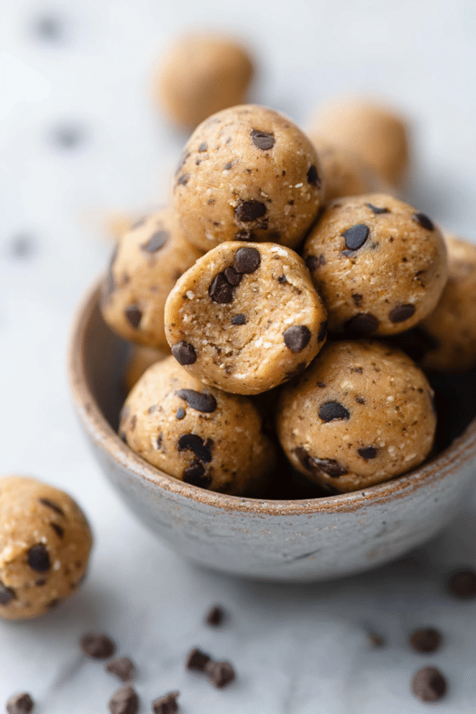 Serving Keto Peanut Butter Protein Balls with chocolate chips in small bowl