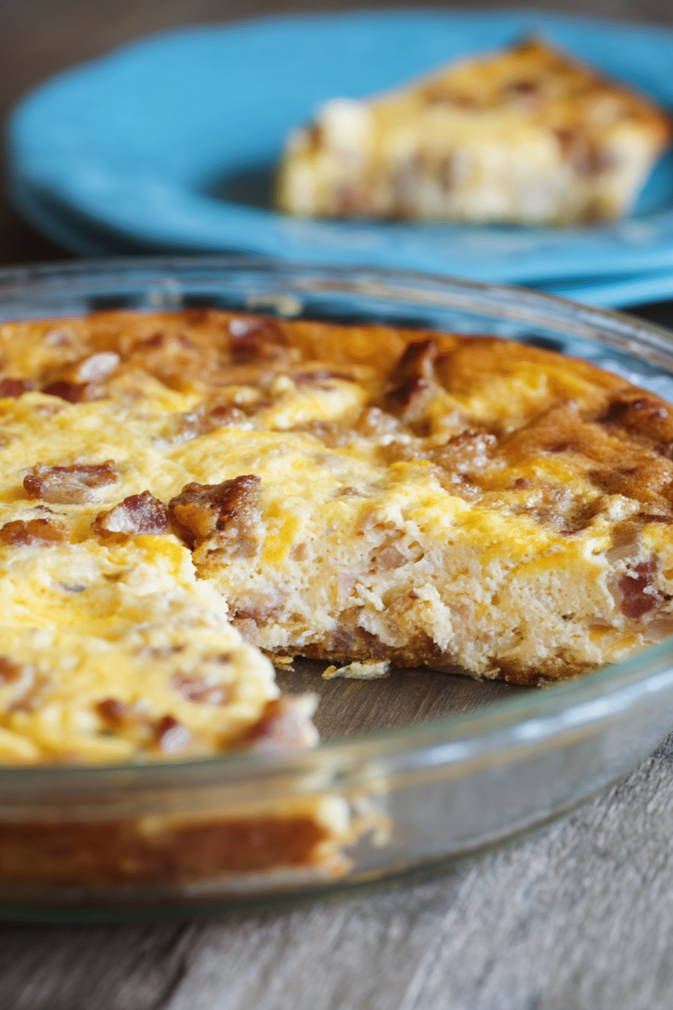 Keto Crustless Quiche Lorraine with a Slice Missing Keto Crustless Quiche Lorraine with slice removed in glass dish