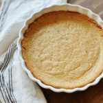 Close-up of a golden almond flour quiche crust with crisp edges