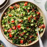 Colorful tabbouleh salad with cucumber, tomato, parsley, and mint